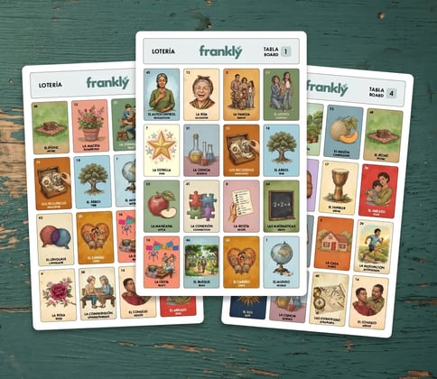 Lotería calling cards fanned out with tabla boards and game box